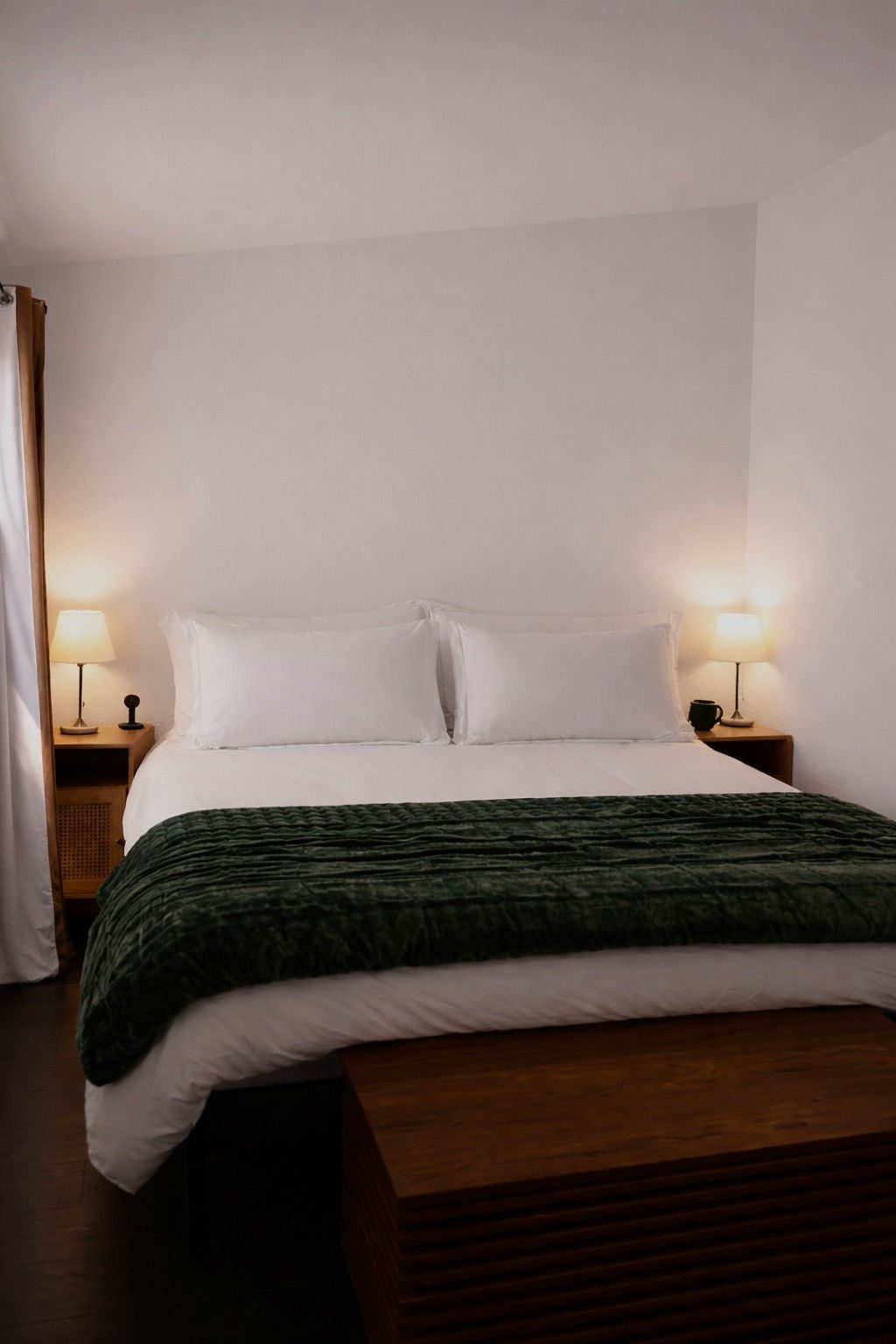 King bed with green velvet throw